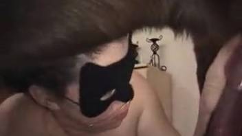 Masked bestiality-loving girl adores a canine's cock